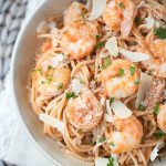 Simple and economical, this Shrimp Pasta is made with whole wheat spaghetti and is tossed with a homemade spicy tomato cream sauce. Ready to serve in under 30 minutes!