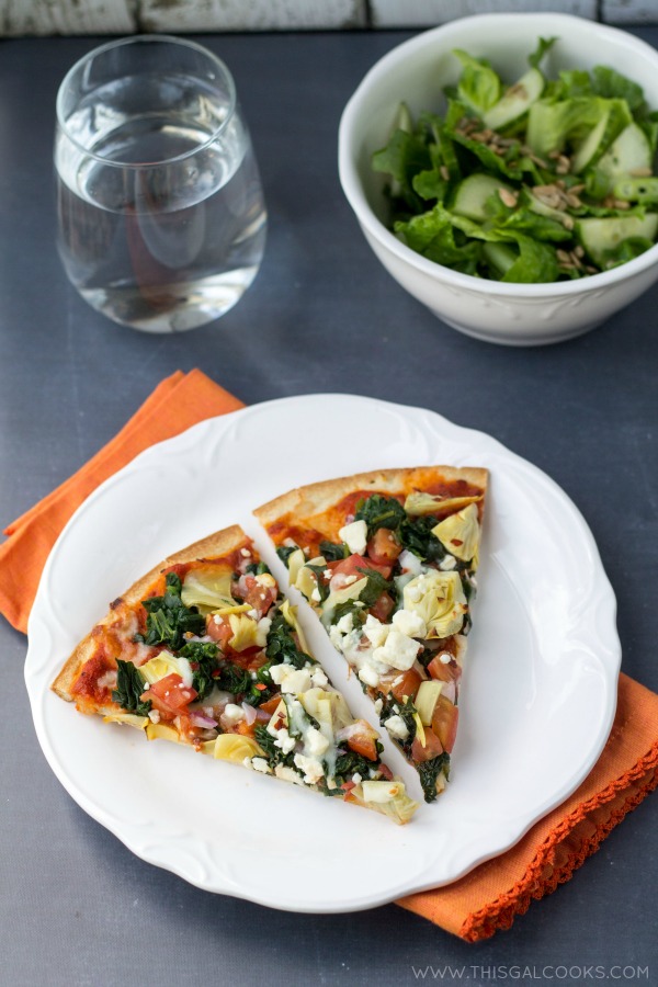 Healthy Tomato Spinach and  Artichoke Pizza from www.thisgalcooks. This pizza is healthy, packed with flavor and super easy to make! #pizza #vegetarian wm