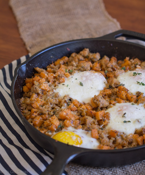 Chicken Sausage and Sweet Potato Hash with Baked Eggs is one of my favorite savory breakfast dishes. Perfectly seasoned, sauteed potatoes with perfectly baked eggs. A MUST try! | This Gal Cooks