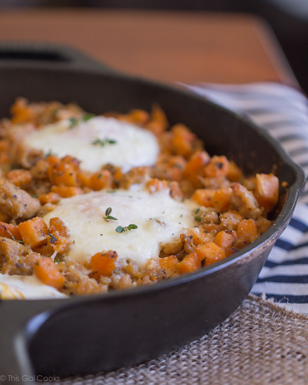 Chicken Sausage and Sweet Potato Hash with Baked Eggs is one of my favorite savory breakfast dishes. Perfectly seasoned, sauteed potatoes with perfectly baked eggs. A MUST try! | This Gal Cooks