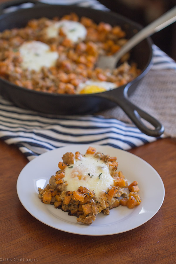 Chicken Sausage and Sweet Potato Hash with Baked Eggs is one of my favorite savory breakfast dishes. Perfectly seasoned, sauteed potatoes with perfectly baked eggs. A MUST try! | This Gal Cooks