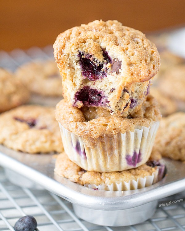 The BEST Blueberry Banana Yogurt Muffins! Topped with a crunchy cinnamon sugar topping and filled with blueberries and chocolate chips!