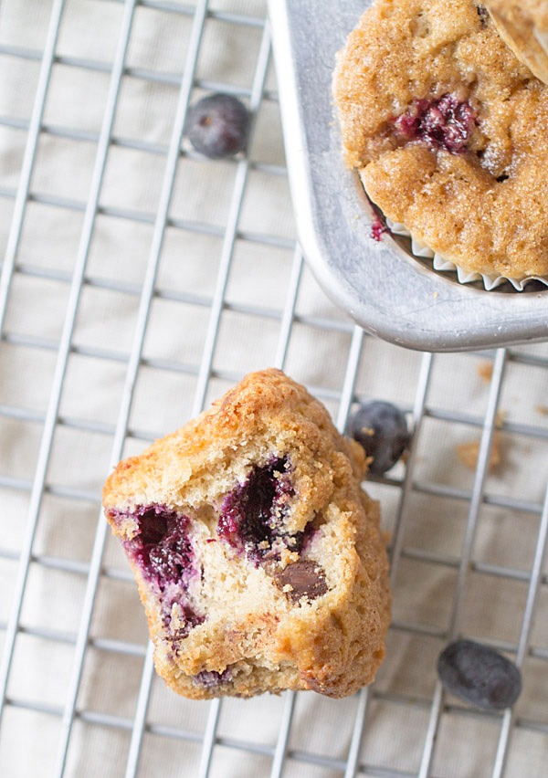 The BEST Blueberry Banana Yogurt Muffins! Topped with a crunchy cinnamon sugar topping and filled with blueberries and chocolate chips!