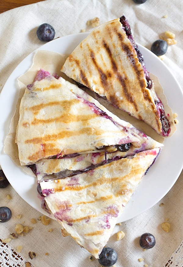 Creamy brie cheese, walnuts and fresh blueberries come together to make this crazy good Blueberry Brie Walnut Quesadilla. Perfect for breakfast or dessert!