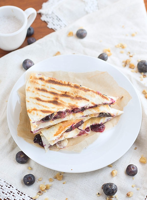 Creamy brie cheese, walnuts and fresh blueberries come together to make this crazy good Blueberry Brie Walnut Quesadilla. Perfect for breakfast or dessert!