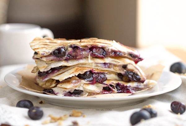 Creamy brie cheese, walnuts and fresh blueberries come together to make this crazy good Blueberry Brie + Walnut Quesadilla. Perfect for breakfast or dessert!