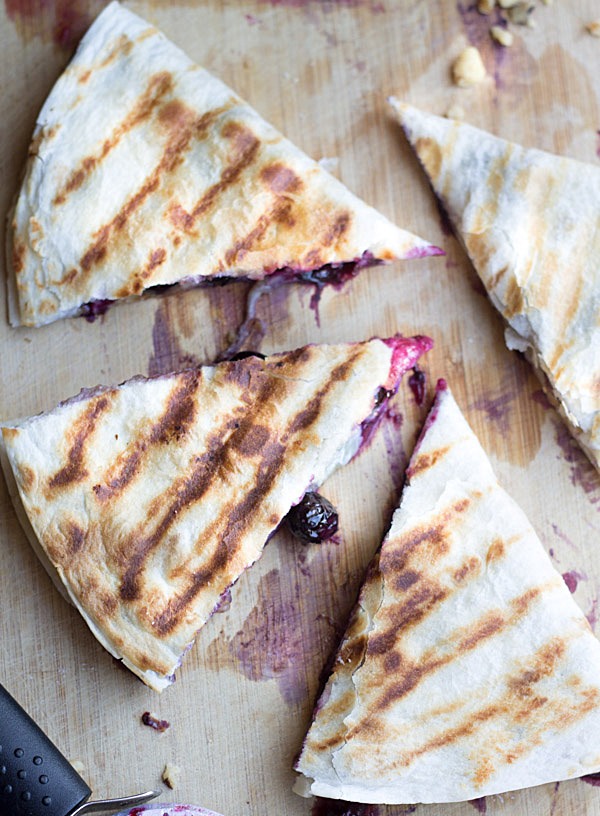 Creamy brie cheese, walnuts and fresh blueberries come together to make this crazy good Blueberry Brie Walnut Quesadilla. Perfect for breakfast or dessert!