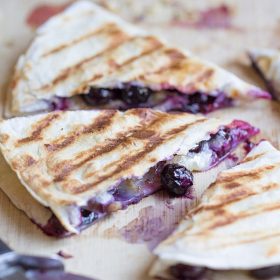 Creamy brie cheese, walnuts and fresh blueberries come together to make this crazy good Blueberry Brie + Walnut Quesadilla. Perfect for breakfast or dessert!