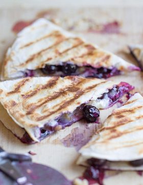 Creamy brie cheese, walnuts and fresh blueberries come together to make this crazy good Blueberry Brie + Walnut Quesadilla. Perfect for breakfast or dessert!