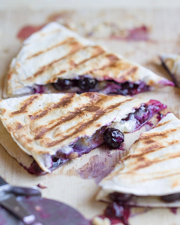 Creamy brie cheese, walnuts and fresh blueberries come together to make this crazy good Blueberry Brie Walnut Quesadilla. Perfect for breakfast or dessert!