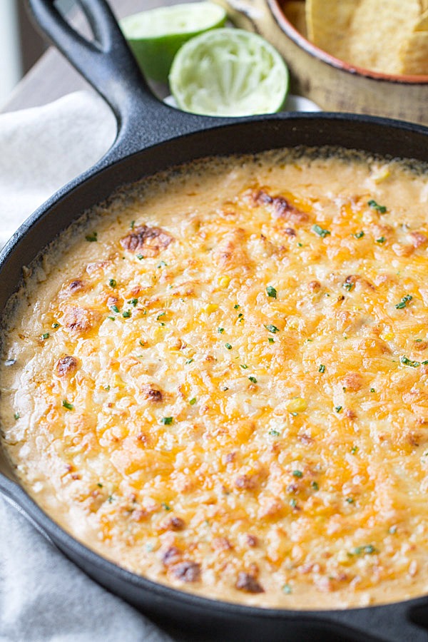 Cheesy Chipotle Shrimp and Corn Dip is my new favorite dip! It's cheesy. It's spicy. It's creamy. It's the kind of appetizer you want to stuff your face with. Perfect for game day! | This Gal Cooks