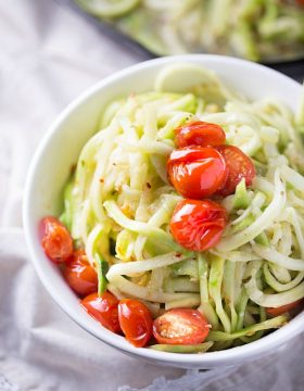 Simple and healthy, these zucchini noodles are paired with roasted tomatoes and a light white wine sauce. Cooked in one skillet to cut back on the clean-up.