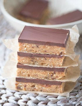 These gluten free Homemade Snack Bars are packed with raw cashews and almonds, dates and coconut flour. They're sweetened with honey and maple syrup. And for an extra boost of flavor, they're topped with a delicious layer of dark chocolate!