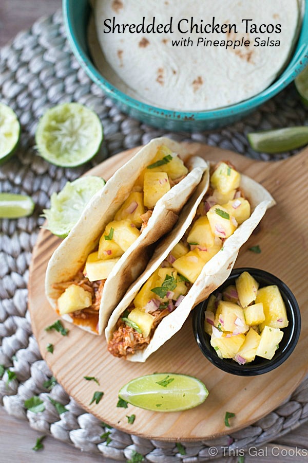 Shredded Chicken Tacos are a simple and delicious dinner recipe that's made in your slow cooker. The tacos are topped with an out of this world fresh homemade pineapple salsa!