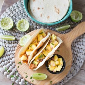 Shredded Chicken Tacos are a simple and delicious dinner recipe that's made in your slow cooker. The tacos are topped with an out of this world fresh homemade pineapple salsa!