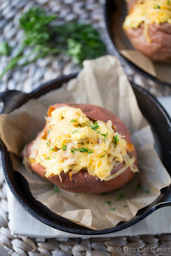 These healthier Breakfast Sweet Potatoes are stuffed with scrambled eggs, chicken sausage, and shredded smoked gouda cheese. Only 300 calories per serving, low fat and low sugar!