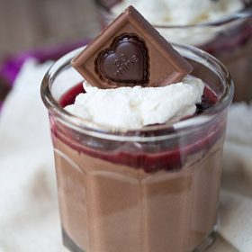 Smooth and creamy homemade chocolate pudding cups are topped with homemade cherry sauce and homemade whipped cream. Delicious and simple to make