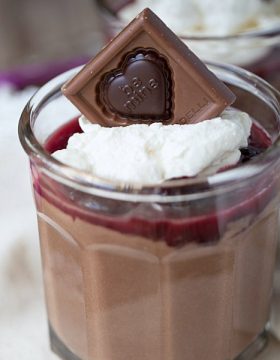 Smooth and creamy homemade chocolate pudding cups are topped with homemade cherry sauce and homemade whipped cream. Delicious and simple to make