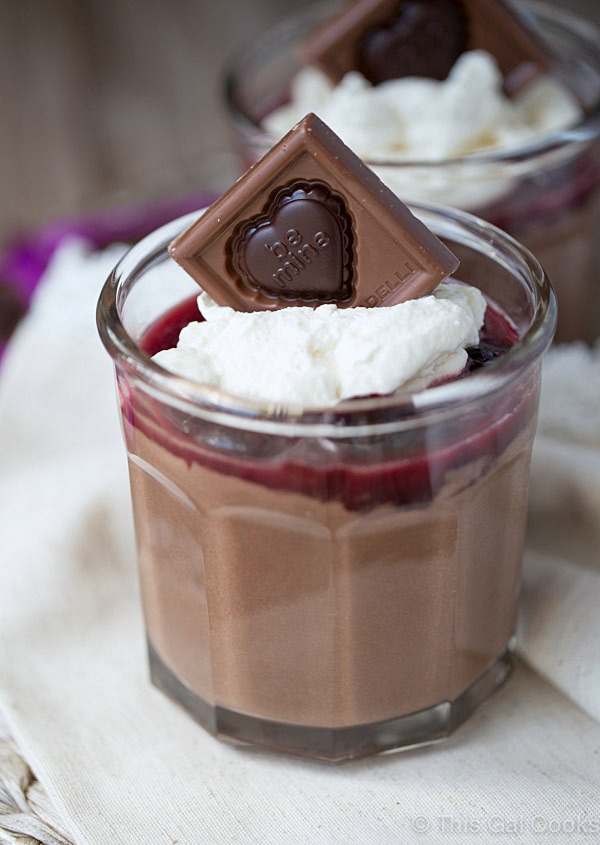 Smooth and creamy homemade chocolate pudding cups are topped with homemade cherry sauce and homemade whipped cream. Delicious and simple to make