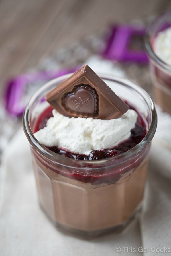 Smooth and creamy homemade chocolate pudding cups are topped with homemade cherry sauce and homemade whipped cream. Delicious and simple to make