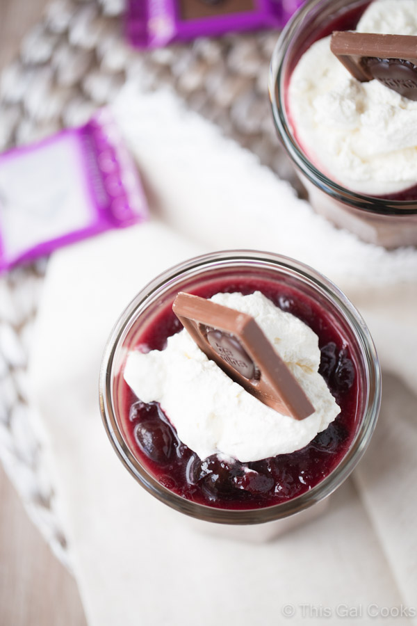 Smooth and creamy homemade chocolate pudding cups are topped with homemade cherry sauce and homemade whipped cream. Delicious and simple to make