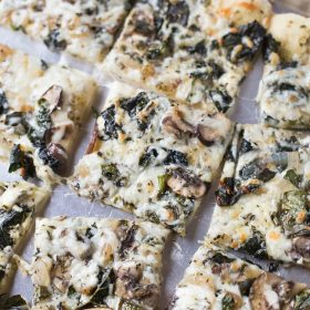 Save money by making your own homemade veggie pizza. Loaded with kale, mushrooms and basil pesto!