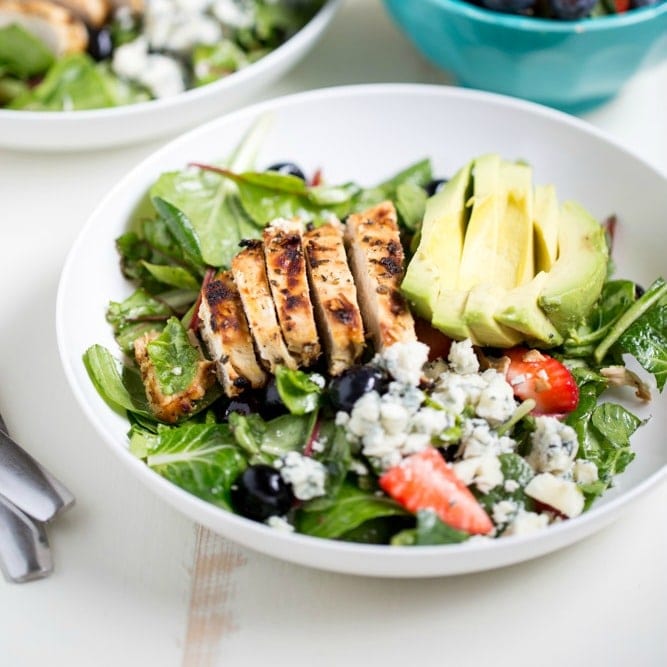 Gorgonzola Chicken Salad with Berries and Avocado is a fresh and healthy salad full of fresh fruit, gorgonzola, super greens and it's dressed with homemade honey balsamic vinaigrette!