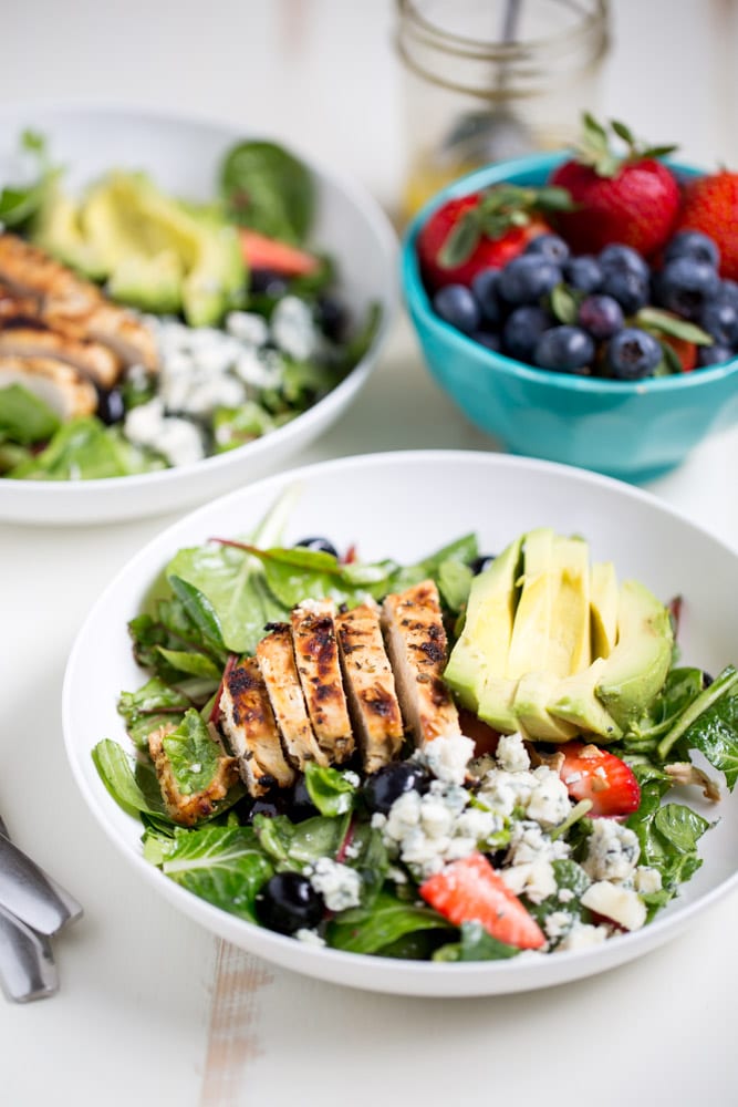 Gorgonzola Chicken Salad with Berries and Avocado is a fresh and healthy salad full of fresh fruit, gorgonzola, super greens and it's dressed with homemade honey balsamic vinaigrette!