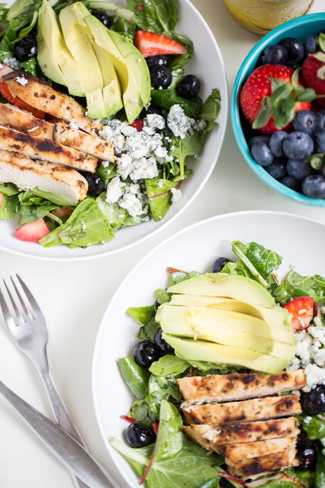 Gorgonzola Chicken Salad with Berries and Avocado is a fresh and healthy salad full of fresh fruit, gorgonzola, super greens and it's dressed with homemade honey balsamic vinaigrette!