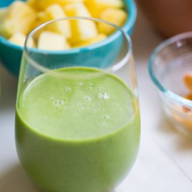 Tropical Kale Smoothie is packed with tons of healthy kale! Mango and pineapple add a bit of sweetness and tropical flavor and plain yogurt make it irresistibly creamy.