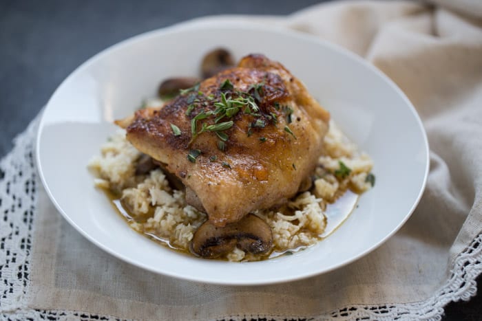 One Skillet Chicken Thighs and Mushrooms with Cauliflower Rice is an easy one skillet dinner recipe that’s ready to eat in under an hour. It’s low carb and gluten free and is made with real ingredients.