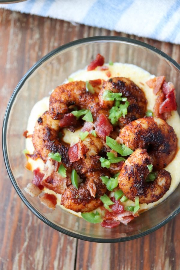 Flavorful blackened shrimp and grits made with smoked gouda cheese are a perfect quick and easy meal! Full of BOLD flavors. You can't beat a bowl of creamy cheese grits topped with shrimp and bacon.