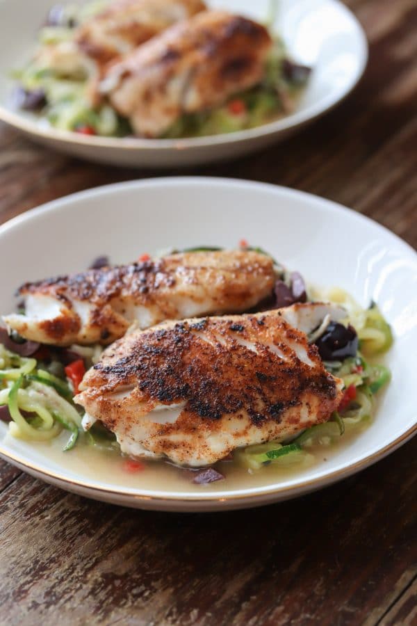 Delicious and healthy mediterranean seasoned Black Sea Bass served with grain free and low carb zucchini noodles. SO easy to make and ready to serve in under 30! #seafood #seabass #lowcarb #glutenfree #dinner #keto