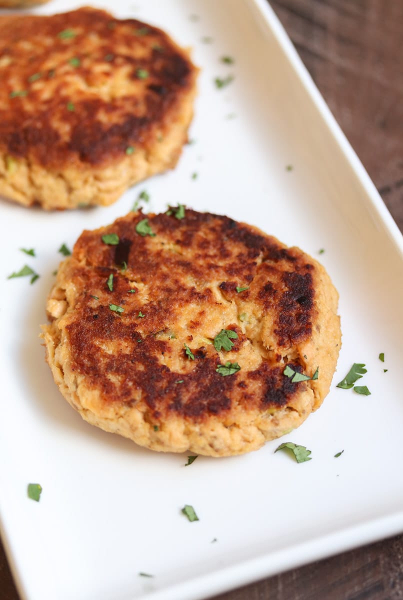 The easiest salmon cakes you'll ever make! These paleo salmon cakes are made with canned salmon, paleo mayo, spices, and almond flour! Serve them as an appetizer or with your favorite veggie for a complete healthy meal. #paleo #salmon #savory #dinner #appetizer