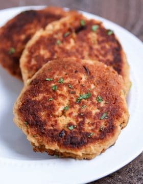 The easiest salmon cakes you'll ever make! These paleo salmon cakes are made with canned salmon, paleo mayo, spices, and almond flour! Serve them as an appetizer or with your favorite veggie for a complete healthy meal. #paleo #salmon #savory #dinner #appetizer